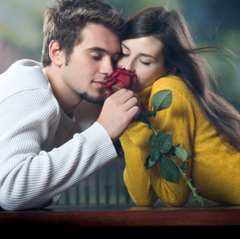 Young couple with rose, outdoors